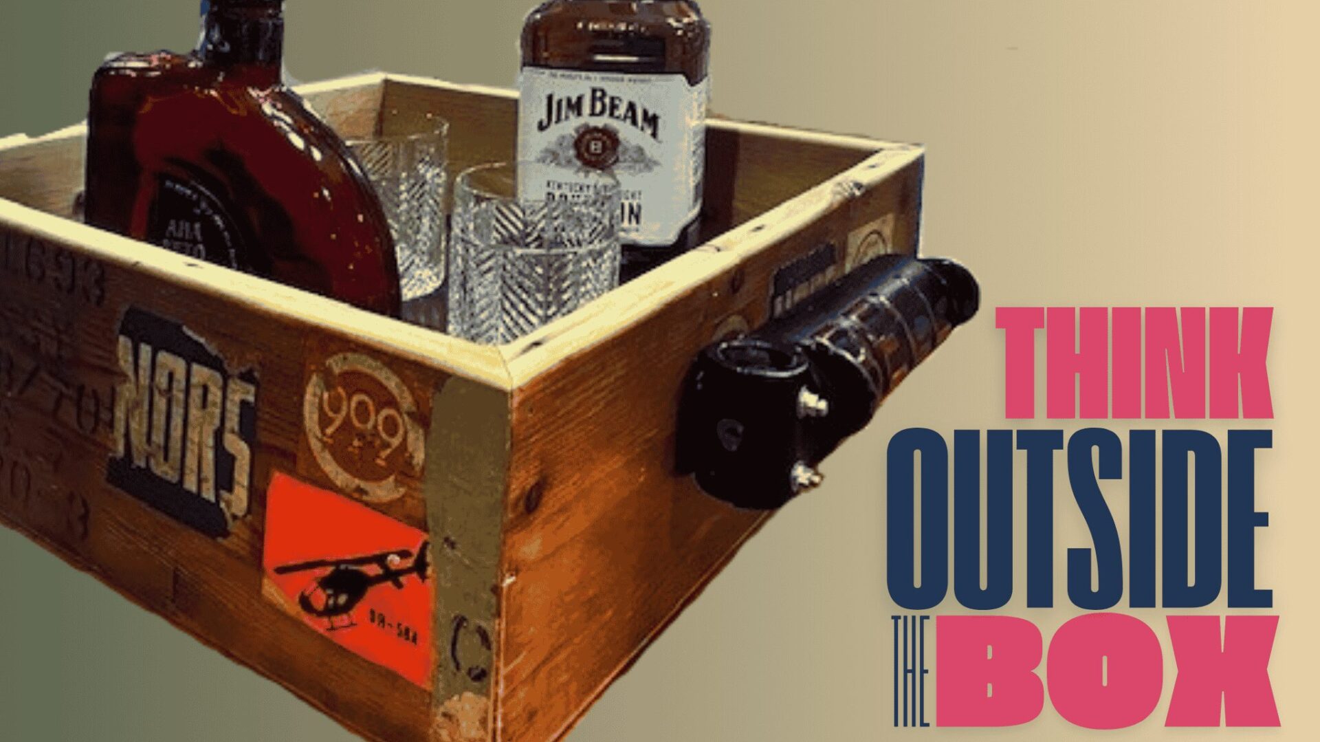 Repurposed alcohol caddy made from a 1960s wooden aviation crate with aged patina, weathered vintage stickers, and a Bell rudder pedal as a unique handle, set against a rustic background